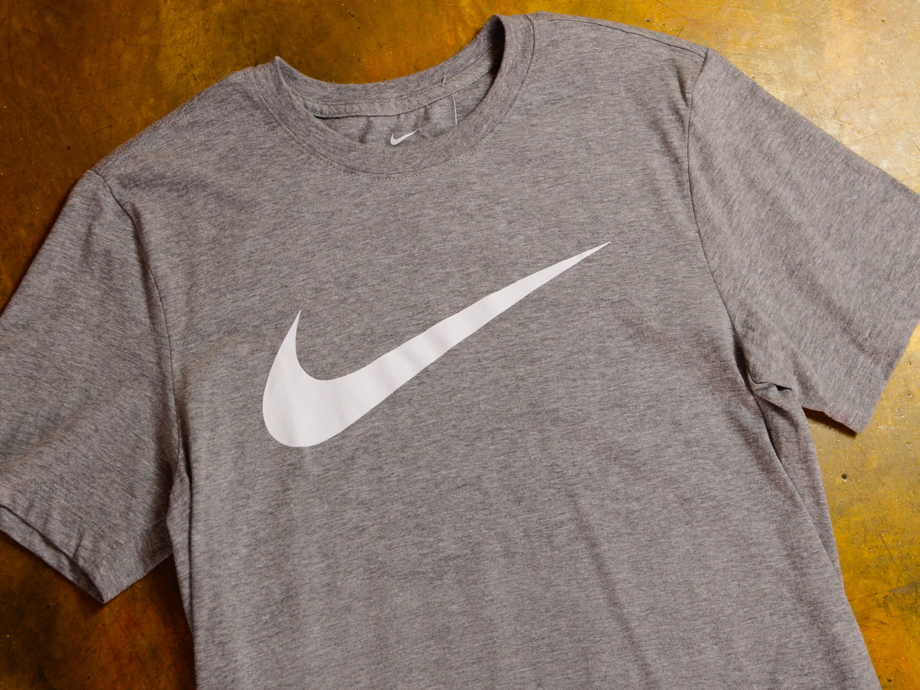 grey nike shirt with white swoosh